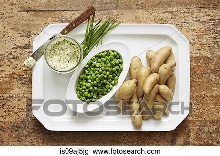 Fingerling potatoes and spring peas served with a chive compound butter View Large Photo Image Stock Image - Fingerling potatoes and spring peas served with a chive compound butter. Fotosearch