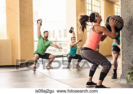 Group of adults doing crossfit workout View Large Photo Image Stock Photograph - Group of adults doing crossfit workout. Fotosearch