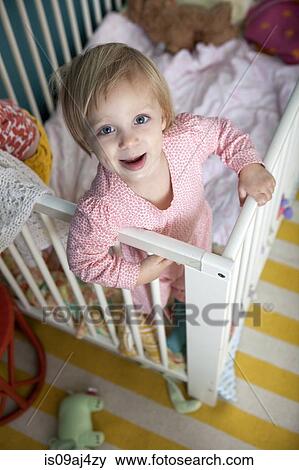 High angle portrait of female toddler in crib View Large Photo Image Stock Photo - High angle portrait of female toddler in crib. Fotosearch