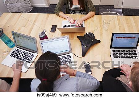 High angle view of women working on laptops View Large Photo Image Stock Photo - High angle view of women working on laptops. Fotosearch