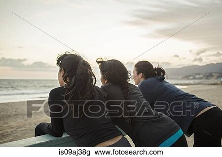 Stock Image - Joggers enjoying view on beach. Fotosearch