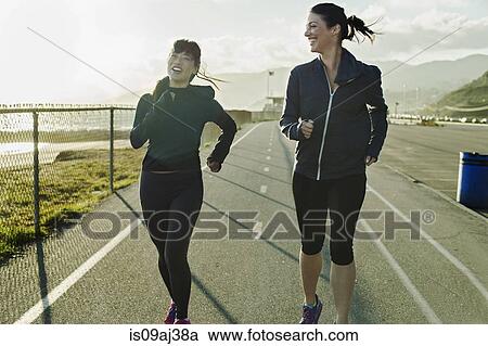 Stock Image - Joggers running on road. Fotosearch