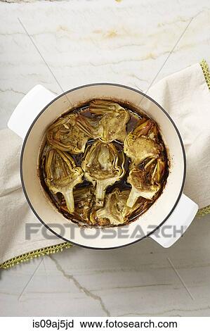Lemon-braised globe artichokes roasted in a casserole View Large Photo Image Stock Image - Lemon-braised globe artichokes roasted in a casserole. Fotosearch
