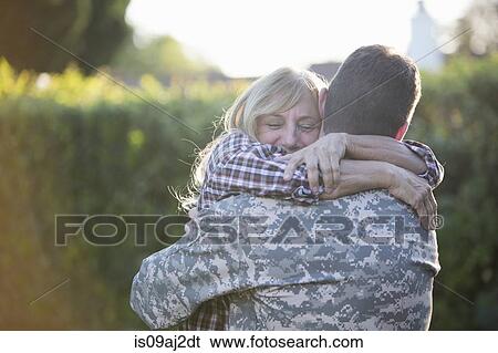 Male soldier hugging mother on street at homecoming View Large Photo Image Stock Photograph - Male soldier hugging mother on street at homecoming. Fotosearch