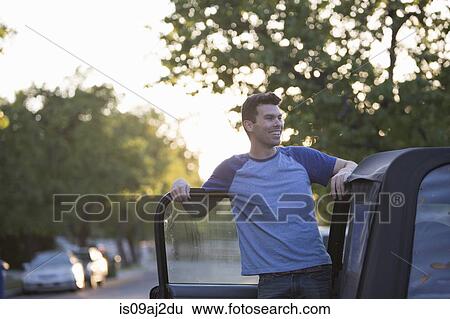 Man leaning against jeep door View Large Photo Image Stock Photograph - Man leaning against jeep door. Fotosearch