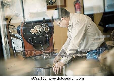 Mature man using coffee roasting machine in cafe View Large Photo Image Stock Photo - Mature man using coffee roasting machine in cafe. Fotosearch