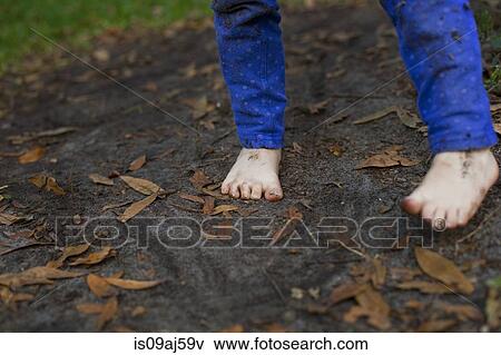 Muddy feet of four year old girl standing in garden soil View Large Photo Image Stock Photo - Muddy feet of four year old girl standing in garden soil. Fotosearch