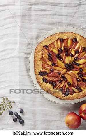Nectarine and blueberry crostata with polenta crush and fresh fruit View Large Photo Image Picture - Nectarine and blueberry crostata with polenta crush and fresh fruit. Fotosearch