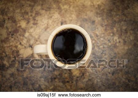Overhead view of cup of black coffee on cafe counter View Large Photo Image Stock Image - Overhead view of cup of black coffee on cafe counter. Fotosearch