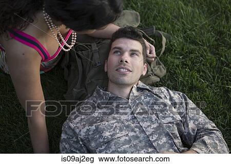 Stock Image - Overhead view of male soldier and wife in garden. Fotosearch
