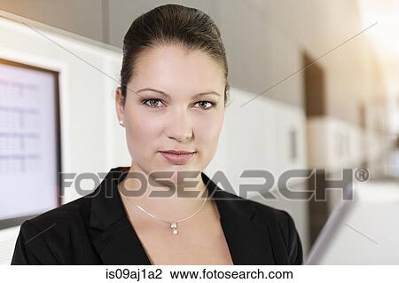 Stock Image - Portrait of businesswoman with digital tablet. Fotosearch