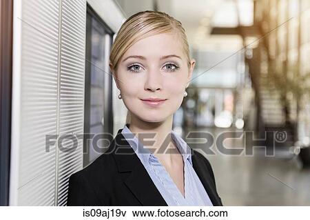 Stock Photo - Portrait of confident young businesswoman in office. Fotosearch