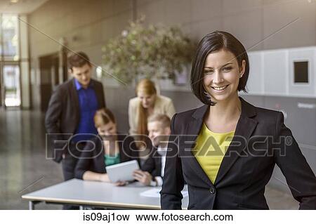 Portrait of confident young businesswoman in office View Large Photo Image Stock Photo - Portrait of confident young businesswoman in office. Fotosearch