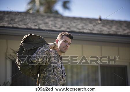 Portrait of intense looking male soldier in garden on homecoming View Large Photo Image Stock Image - Portrait of intense looking male soldier in garden on homecoming. Fotosearch