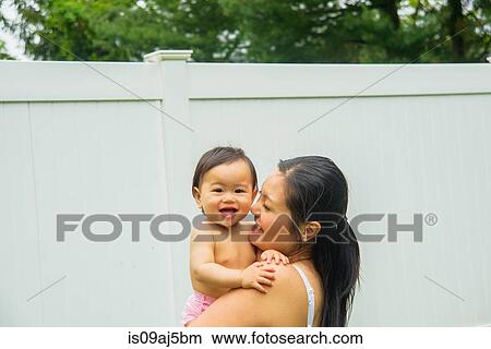 Portrait of mid adult mother and baby boy in garden View Large Photo Image Picture - Portrait of mid adult mother and baby boy in garden. Fotosearch