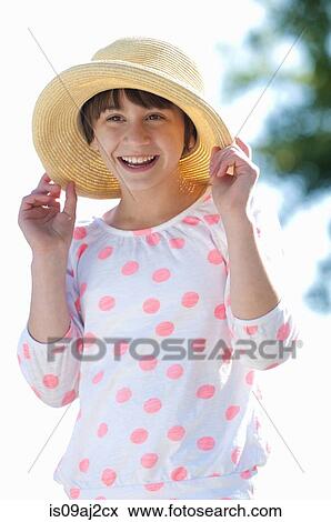 Portrait of ten year old girl holding onto straw hat View Large Photo Image Stock Photo - Portrait of ten year old girl holding onto straw hat. Fotosearch