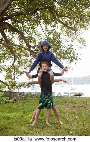 Portrait of three boys, one behind and another on shoulders View Large Photo Image Stock Image - Portrait of three boys, one behind and another on shoulders. Fotosearch