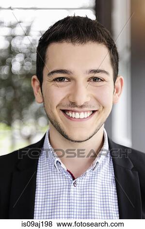 Portrait of young businessman in office View Large Photo Image Stock Photo - Portrait of young businessman in office. Fotosearch