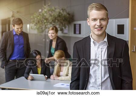 Portrait of young businessman in office View Large Photo Image Stock Photography - Portrait of young businessman in office. Fotosearch