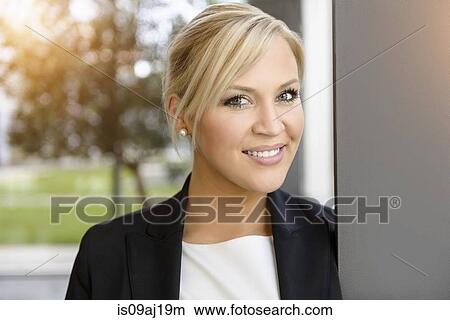 Portrait of young businesswoman in office View Large Photo Image Picture - Portrait of young businesswoman in office. Fotosearch