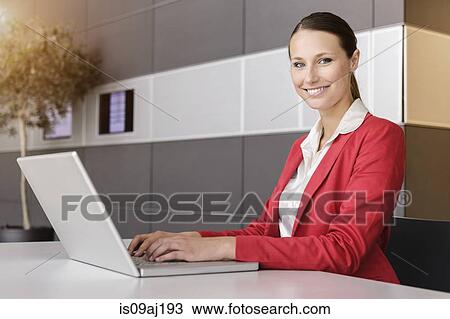 Portrait of young businesswoman using laptop View Large Photo Image Stock Image - Portrait of young businesswoman using laptop. Fotosearch
