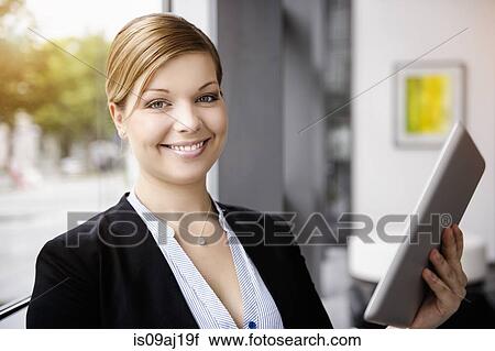 Portrait of young businesswoman using digital tablet View Large Photo Image Stock Image - Portrait of young businesswoman using digital tablet. Fotosearch
