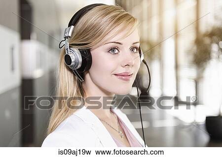 Portrait of young businesswoman using telephone headset View Large Photo Image Stock Photo - Portrait of young businesswoman using telephone headset. Fotosearch