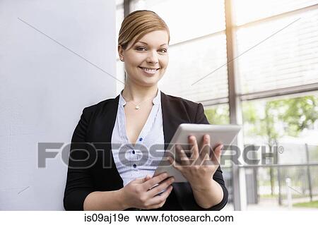 Portrait of young businesswoman with digital tablet View Large Photo Image Stock Image - Portrait of young businesswoman with digital tablet. Fotosearch
