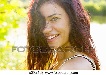 Portrait of young woman with hair hiding face View Large Photo Image Stock Image - Portrait of young woman with hair hiding face. Fotosearch