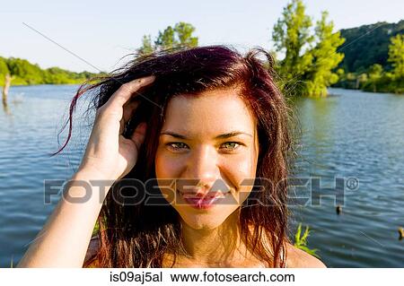 Stock Image - Portrait of young woman with hand in her hair, Delaware Canal State Park, New Hope, Pennsylvania, USA. Fotosearch