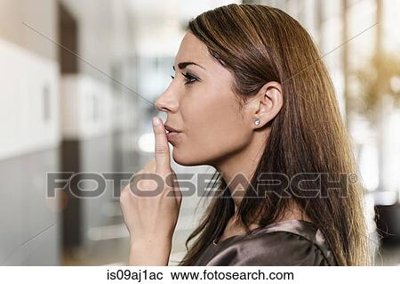 Profile portrait of mid adult businesswoman with finger on lips View Large Photo Image Stock Image - Profile portrait of mid adult businesswoman with finger on lips. Fotosearch