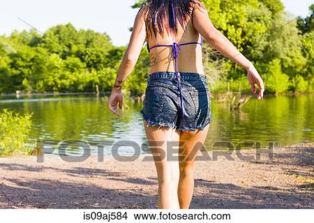 Rear cropped view of young woman walking toward canal, Delaware Canal State Park, New Hope, Pennsylvania, USA View Large Photo Image Picture - Rear cropped view of young woman walking toward canal, Delaware Canal State Park, New Hope, Pennsylvania, USA. Fotosearch