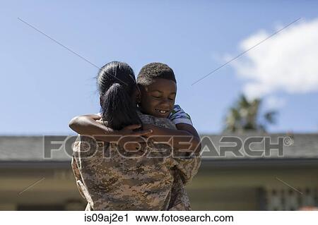 Rear view of female soldier hugging son on homecoming View Large Photo Image Stock Image - Rear view of female soldier hugging son on homecoming. Fotosearch