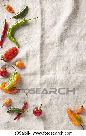 Selection of summer chilli peppers on an ivory linen surface View Large Photo Image Stock Image - Selection of summer chilli peppers on an ivory linen surface. Fotosearch