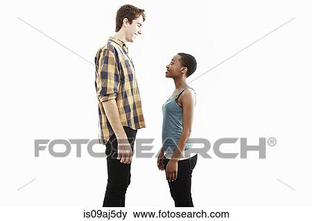 Stock Photo - Side view studio portrait showing contrasting height of young couple. Fotosearch
