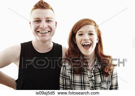 Stock Photography - Studio portrait of red haired young couple laughing. Fotosearch