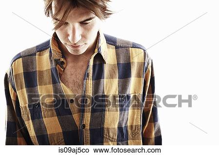 Studio portrait of young man looking down View Large Photo Image Picture - Studio portrait of young man looking down. Fotosearch