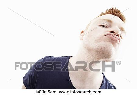 Picture - Studio portrait of young man pulling a face. Fotosearch