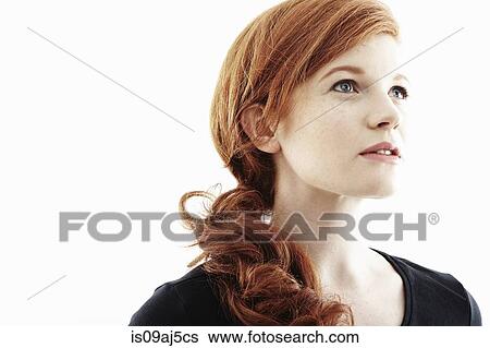 Stock Photograph - Studio portrait of young woman gazing upwards. Fotosearch