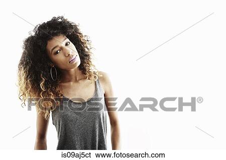 Studio portrait of young woman gazing and leaning over View Large Photo Image Stock Photograph - Studio portrait of young woman gazing and leaning over. Fotosearch