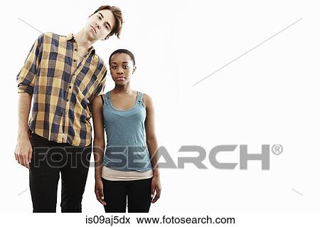 Studio portrait showing contrasting height of young couple View Large Photo Image Stock Photo - Studio portrait showing contrasting height of young couple. Fotosearch