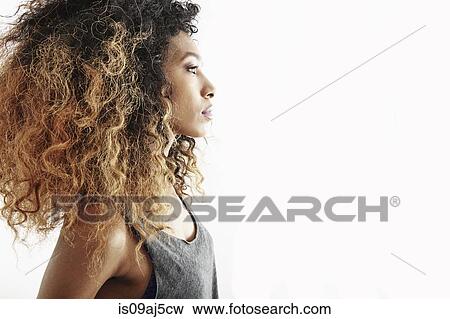 Stock Photo - Studio profile portrait of serious young woman. Fotosearch
