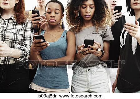 Studio shot of six young adults texting on smartphone View Large Photo Image Stock Photography - Studio shot of six young adults texting on smartphone. Fotosearch