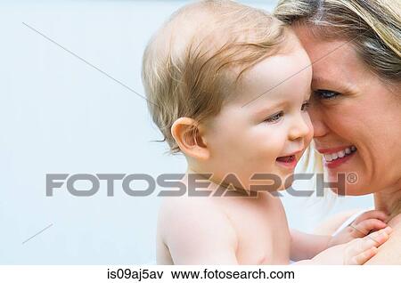 Tender portrait of mid adult mother and baby girl View Large Photo Image Stock Photo - Tender portrait of mid adult mother and baby girl. Fotosearch