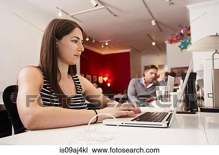 Woman at work at laptop in office View Large Photo Image Stock Image - Woman at work at laptop in office. Fotosearch