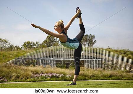 Woman practising yoga in park View Large Photo Image Picture - Woman practising yoga in park. Fotosearch