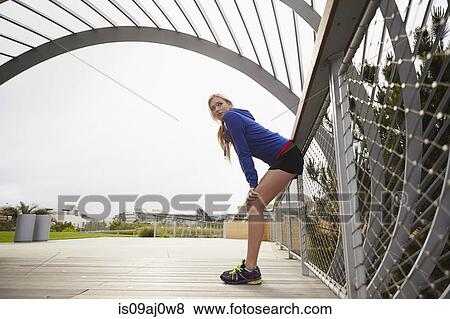 Stock Photo - Woman resting against fence, Tongva Park, Santa Monica, California, USA. Fotosearch