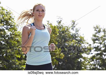 Woman running in park View Large Photo Image Stock Photography - Woman running in park. Fotosearch