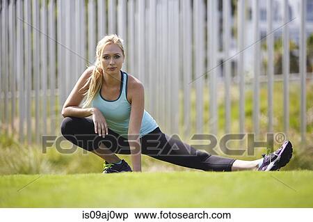 Stock Photography - Woman stretching in park. Fotosearch