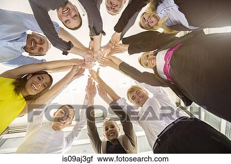 Worms eye view of seven business men and women in a circle holding hands in office View Large Photo Image Stock Image - Worms eye view of seven business men and women in a circle holding hands in office. Fotosearch